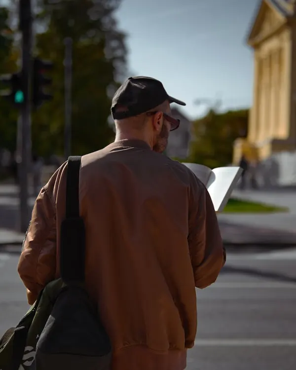 A traveller reading a map on a city street